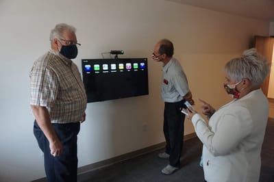 Residents interacting with technology in a facility room