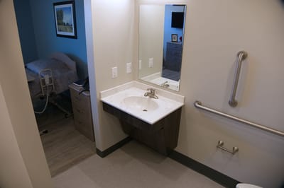 Interior view of a resident bathroom with sink and mirror