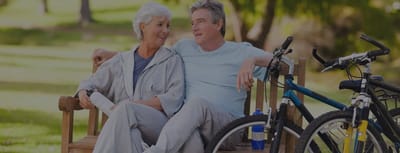 Seniors enjoying time together on a bench in a park