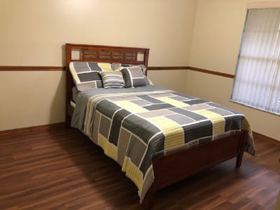 A well-furnished private resident room with a bed