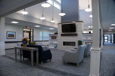 Bright common area with seating and a fireplace