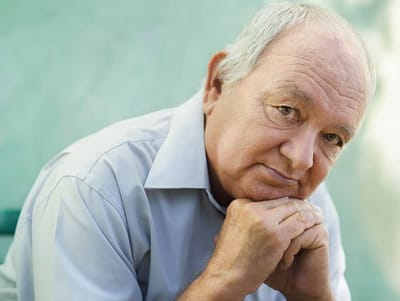 Senior man resting his chin on his hands