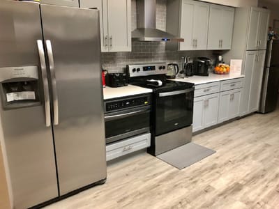 Modern kitchen with silver appliances and light cabinets
