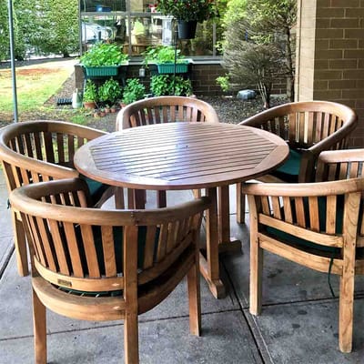 Outdoor seating area with wooden chairs and table
