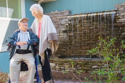 Residents enjoying time together by a water feature