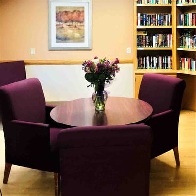 Cozy seating area in a common room with bookshelves