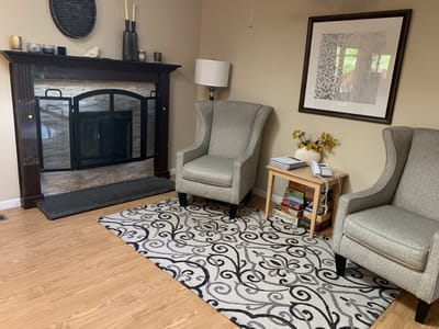 Cozy common area with comfortable chairs and fireplace