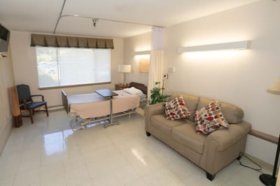 Interior of a resident room with bed and sofa
