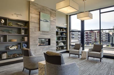 Modern interior of a lounge area with chairs and fireplace