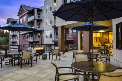 Outdoor seating area with tables and umbrellas