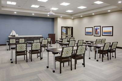 Bright interior room with tables and chairs set up