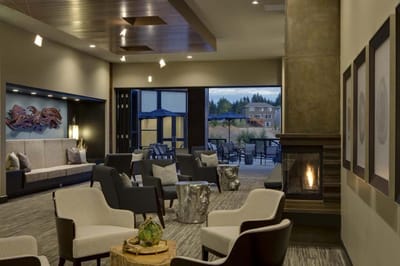 Bright and airy common area with a fireplace