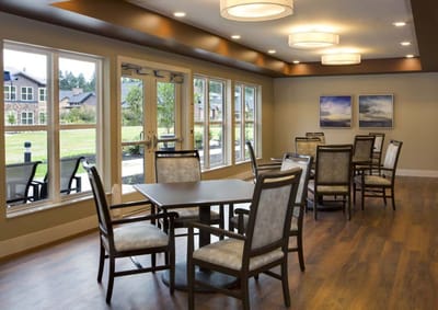 Bright, welcoming common area with tables and chairs