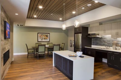 Cozy dining area with well-furnished table and kitchen