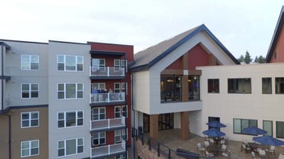 Aerial view of the facility building with outdoor seating areas