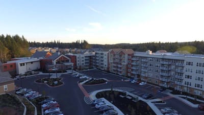 Aerial view of a senior living facility with parking area