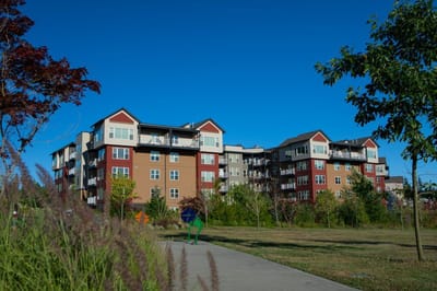 Exterior view of a senior living facility with gardens