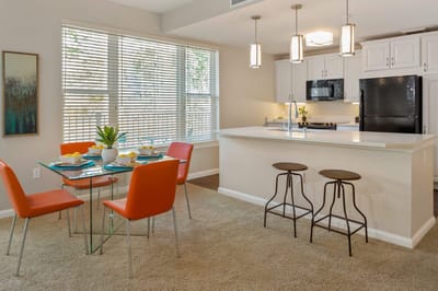 Bright, modern kitchen with dining area in a senior living facility