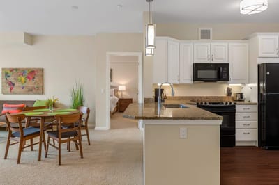 Bright interior of a resident unit showing kitchen and dining area