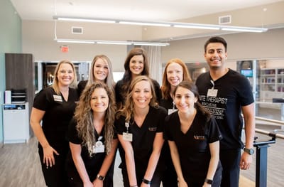 Group of staff members smiling indoors