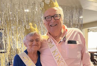 Two residents celebrating with crowns at a party.