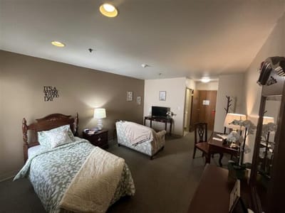 A cozy shared room with two beds and decor.