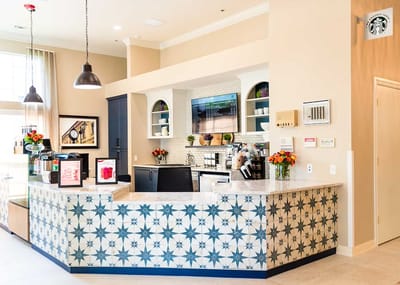 Reception area with floral arrangements and coffee station.