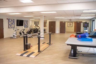 Therapy room with equipment and workout stations.