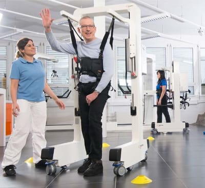 Resident interacting with staff in a rehabilitation setting.