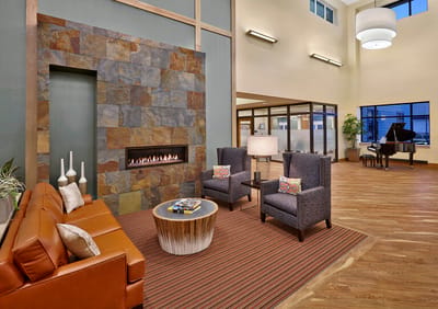 Modern lobby area with seating and a piano