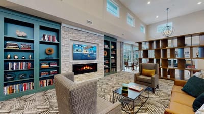 Cozy common area with seating and shelves.