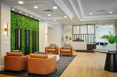 Modern lobby area with seating and greenery