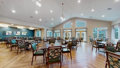 Dining area with tables and chairs in a facility.