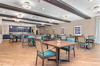Spacious interior of a common area with tables and chairs.