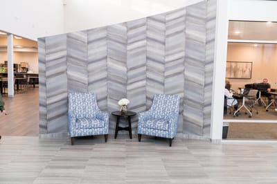Seating area with chairs and a table in a common area.