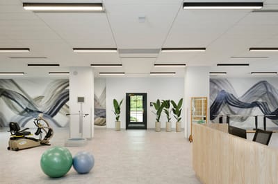 Bright interior space with exercise equipment and decor.