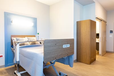 A private resident room with a hospital bed