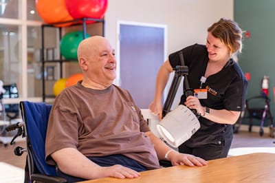 Resident enjoying therapy with staff member