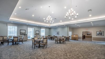 Brightly lit common area with tables and chairs