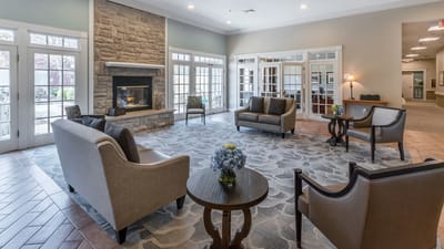 Bright common area with cozy seating and fireplace
