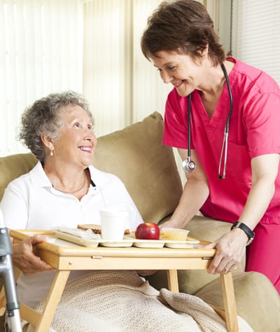 Resident interacting with a caregiver at mealtime