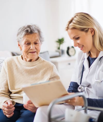 A caregiver reviewing a document with a senior resident