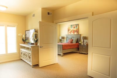 Brightly lit resident bedroom with warm colors