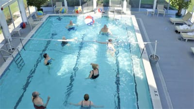 Residents engaging in water volleyball activity