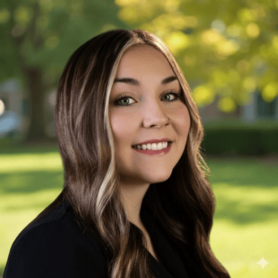Smiling woman outdoors with green background.