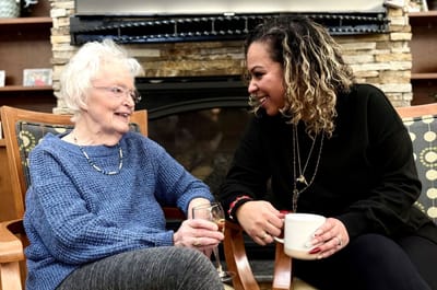 Resident enjoying conversation with staff member