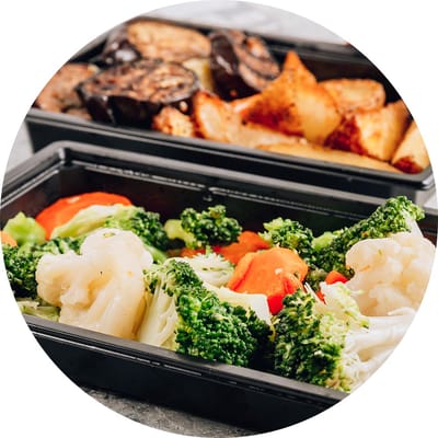 Healthy meal with vegetables in a black container