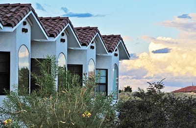 Exterior view of facility with decorative architecture and landscaping.