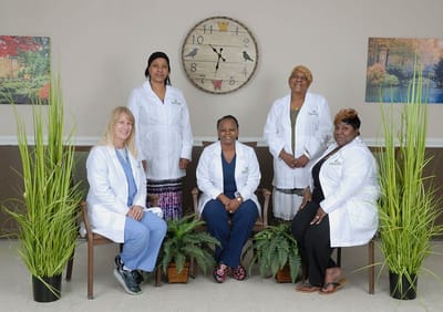 Staff in lab coats posing in a common area