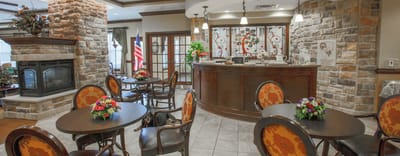 Common area lounge with stone fireplace and seating